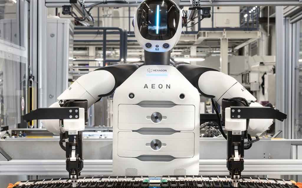 BMW AEON humanoid robot working alongside factory employees at the Leipzig plant during electric vehicle battery assembly