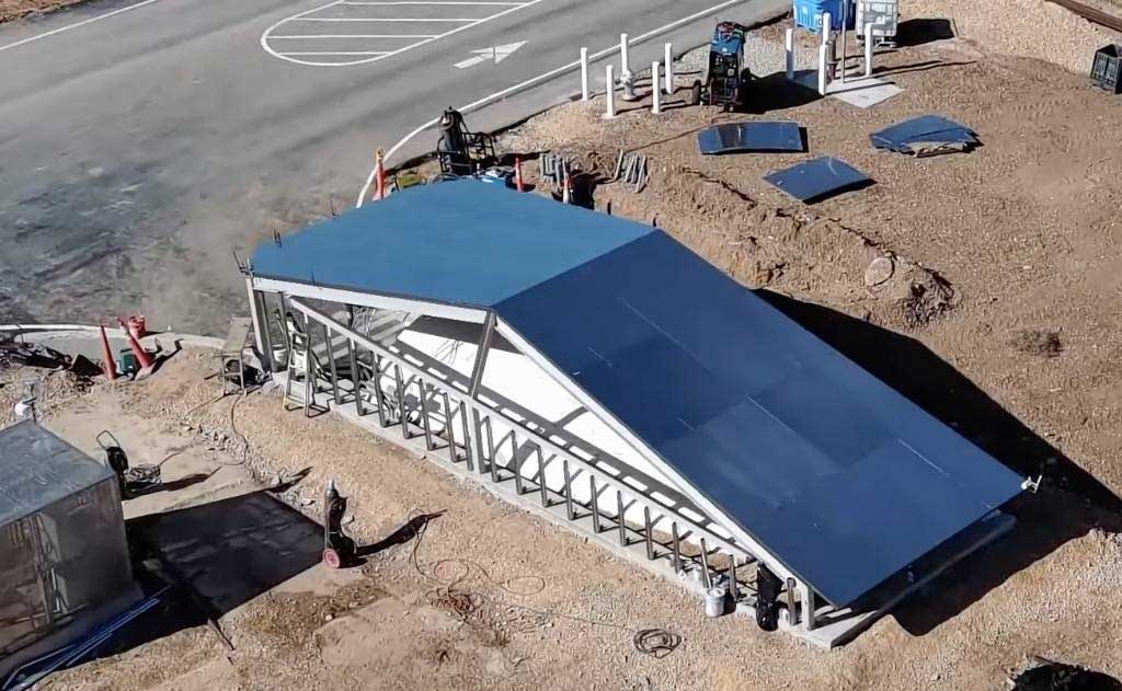 Tesla Cybertunnel at Giga Texas with Cybertruck emerging from the birthing tunnel