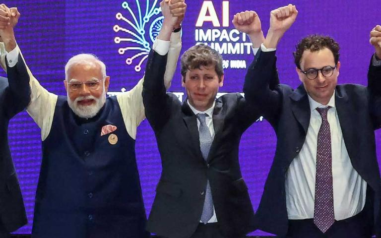 Sam Altman and Dario Amodei standing beside PM Narendra Modi during a tense moment at India AI Impact Summit 2026