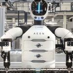 BMW AEON humanoid robot working alongside factory employees at the Leipzig plant during electric vehicle battery assembly