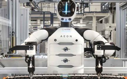 BMW AEON humanoid robot working alongside factory employees at the Leipzig plant during electric vehicle battery assembly