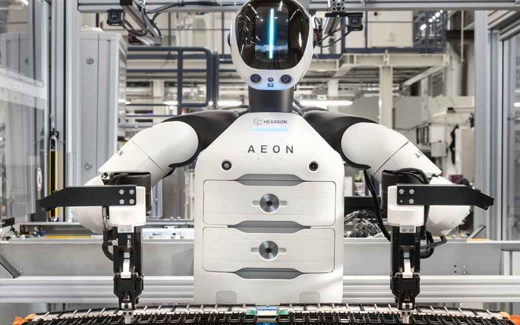 BMW AEON humanoid robot working alongside factory employees at the Leipzig plant during electric vehicle battery assembly