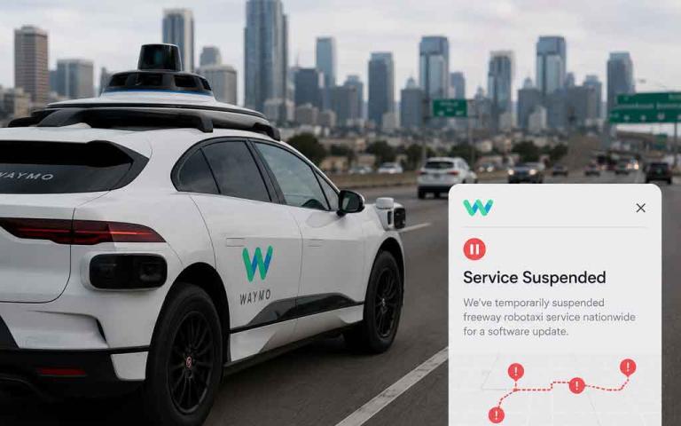 Waymo autonomous robotaxi navigating urban streets with AI driving systems, freeway suspension alerts, smart mobility technology, and futuristic self-driving transportation