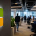 Microsoft logo with AI graphics and Xbox controller representing Microsoft's 4,800 job cuts and AI investment strategy.
